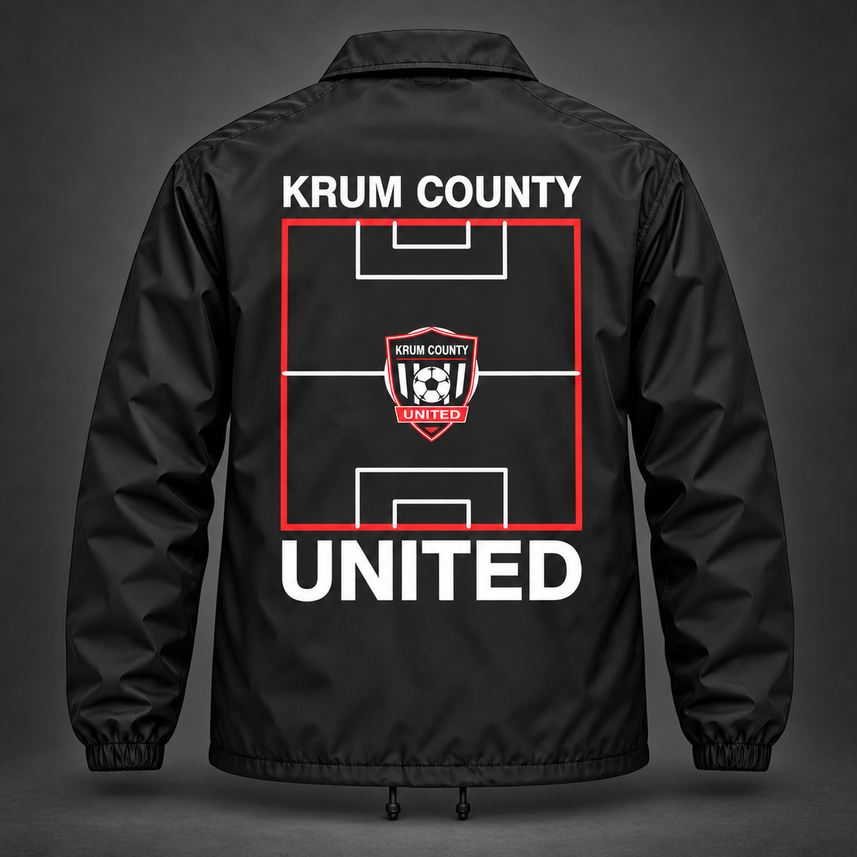 Back of the black Krum County United coach jacket with a red pitch diagram, crest, and UNITED lettering.