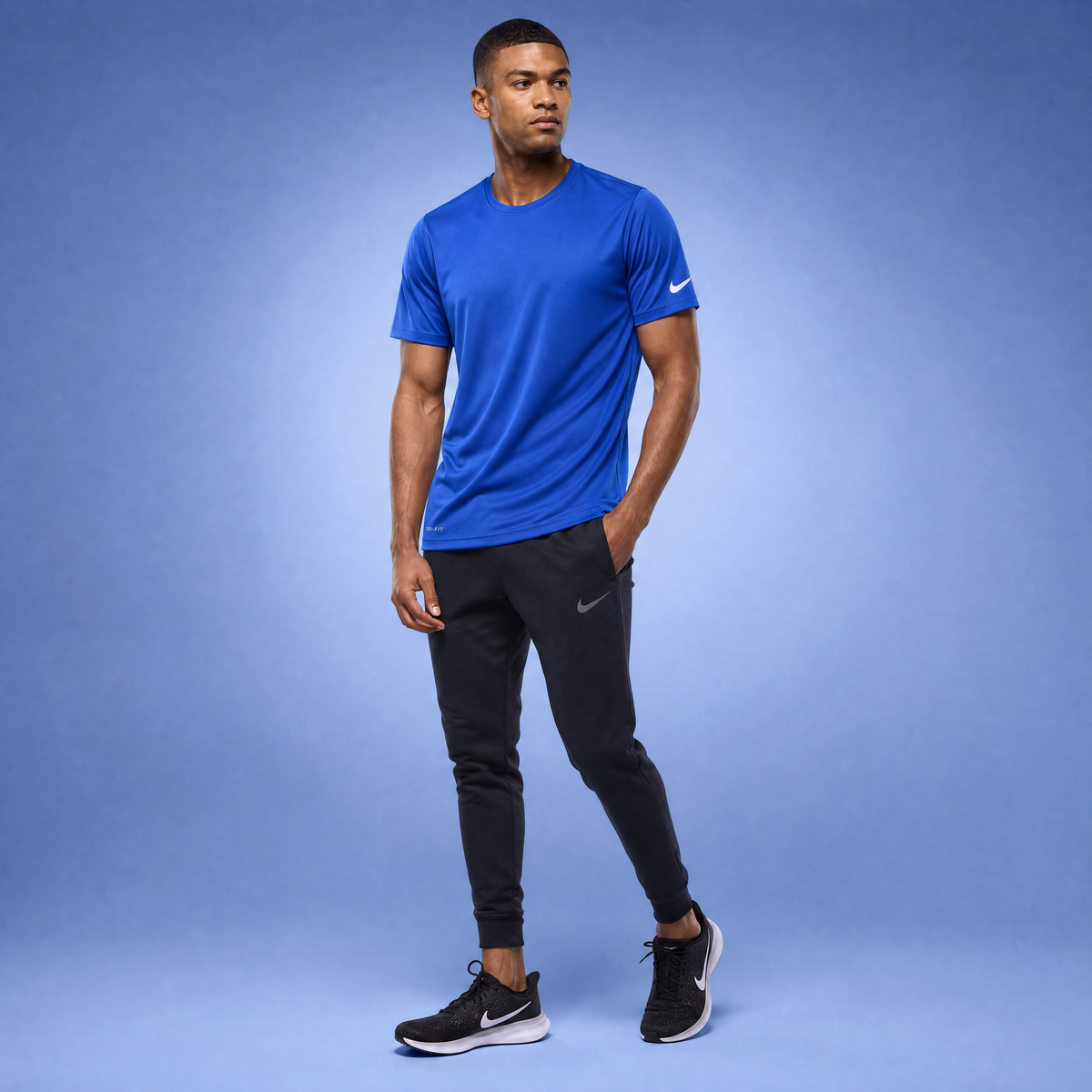 Male athlete modeling the royal blue Nike Cotton Short Sleeve Men's Tee
