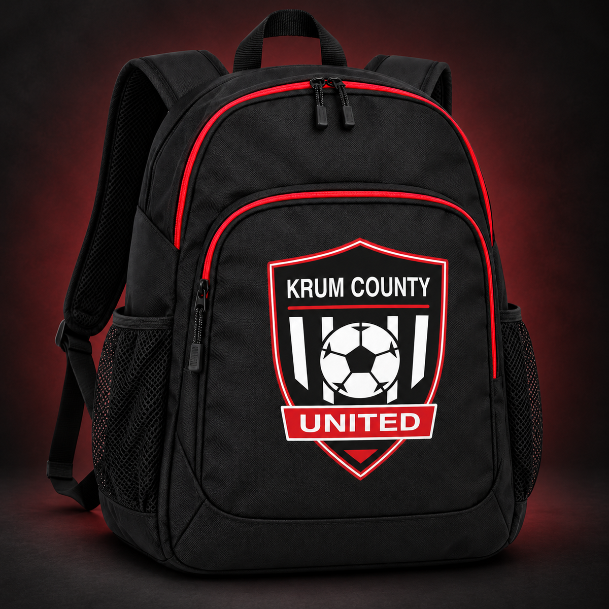 Black soccer backpack with red trim and a red, black, and white Krum County United crest on the front pocket.