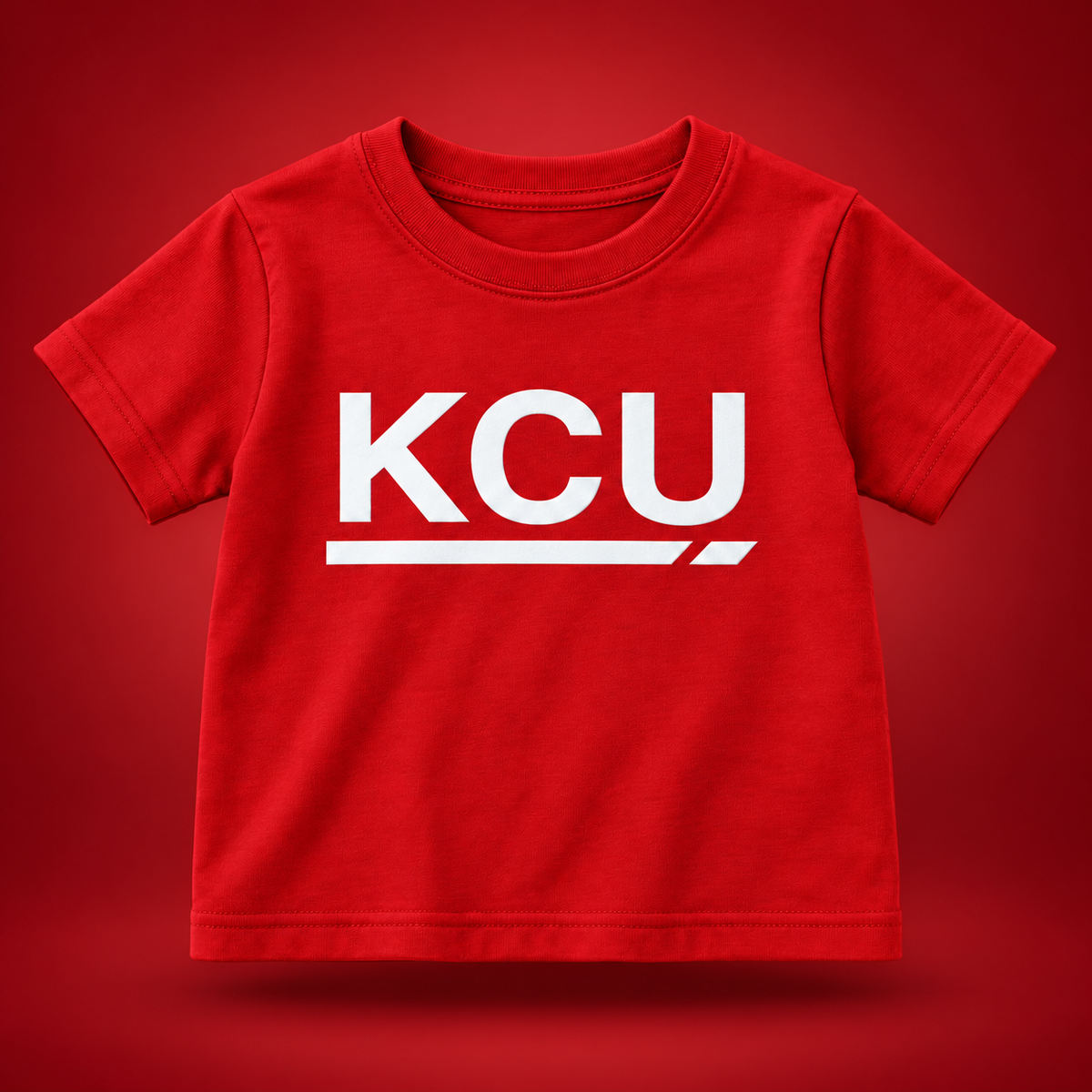 Red toddler T-shirt with a large white KCU monogram and segmented underline on the front.